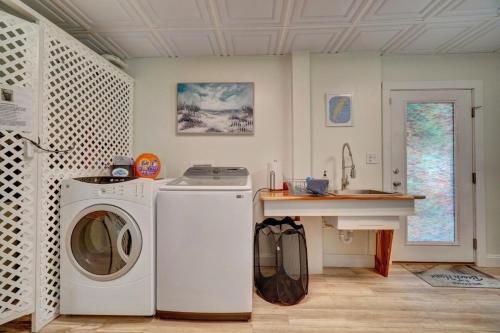 a laundry room with a washing machine and a counter at Beach Front - Hot Tub - Game Room - 3500SQFT in Cape Charles