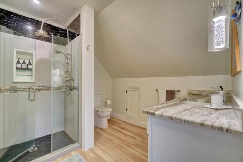 a bathroom with a shower and a sink and a toilet at Beach Front - Hot Tub - Game Room - 3500SQFT in Cape Charles