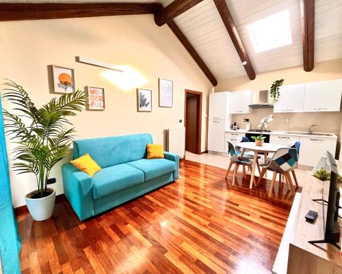 a living room with a blue couch and a table at La Casa di Totta in San Maurizio Canavese