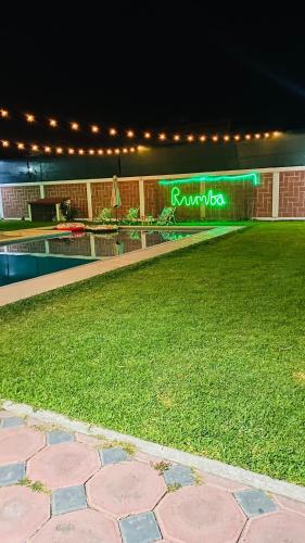 a building with a sign that reads roussegas at night at Heated pool, Casa Senda del Son-Cuautla in Los Limones