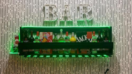 a shelf with bottles of alcohol on a wall at Heated pool, Casa Senda del Son-Cuautla in Los Limones
