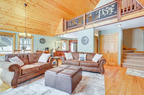 a living room with leather furniture and a wooden ceiling at Hike, Ski and Raft Terra Alta Cabin with Large Deck in Terra Alta