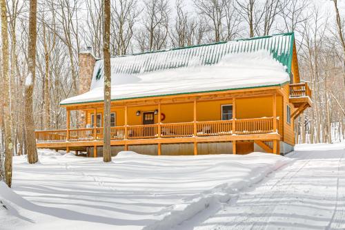 a log cabin in the woods in the snow at Hike, Ski and Raft Terra Alta Cabin with Large Deck in Terra Alta