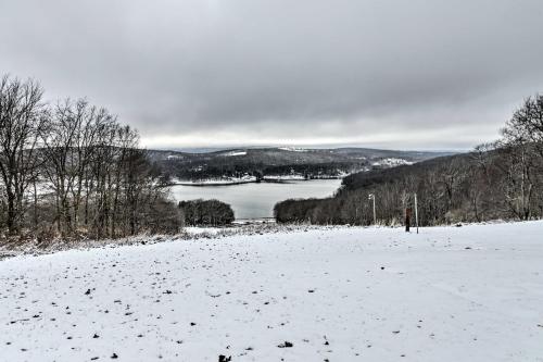 a snow covered field with a view of a lake at Hike, Ski and Raft Terra Alta Cabin with Large Deck in Terra Alta
