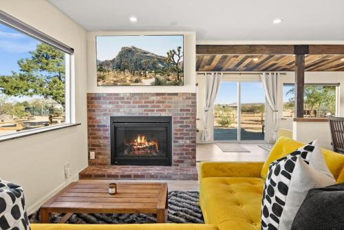 a living room with a fireplace and a yellow couch at Number 1 Joshua Tree Escape-Heated Pool in Landers