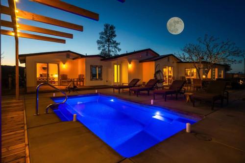 a swimming pool in a backyard at night at Number 1 Joshua Tree Escape-Heated Pool in Landers