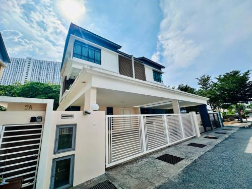 a house with a white fence in front of it at New Sea Breeze Landed Home 13pax BatuFerrigghi in Batu Ferringhi