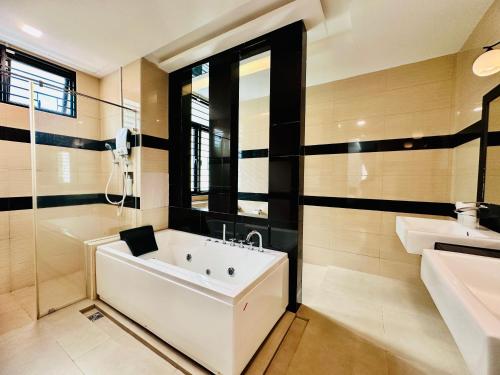 a white bath tub in a bathroom with a sink at New Sea Breeze Landed Home 13pax BatuFerrigghi in Batu Ferringhi