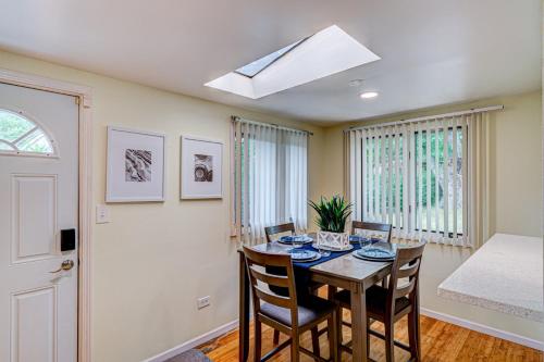 a dining room with a table and chairs and a skylight at Cozy Home Sleeps 10 Lombard Chicago Suburb in Lombard