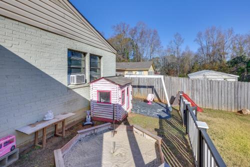 a backyard with a play house and a fence at 14 Mi to Montgomery Quaint Couples Apartment in Prattville