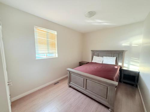 a bedroom with a bed and a window at Super 8 by Wyndham Salmon Arm in Salmon Arm