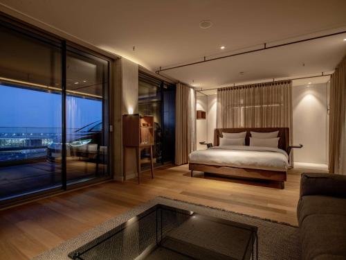 a bedroom with a bed and a large window at b'mine Hotel Frankfurt Airport in Frankfurt/Main