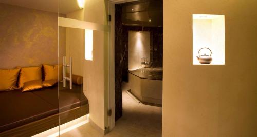 a room with a couch and a sink in a room at Wellness-& Nationapark Hotel Schliffkopf, BWSC in Baiersbronn