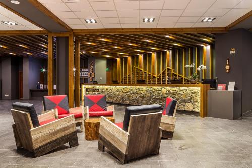 a lobby with chairs and a bar in a building at Rila Hotel Borovets in Borovets