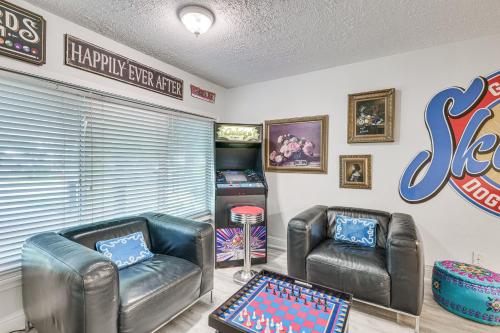 a room with two leather chairs and a game room at Tomball Home with Game Room Walk to Main Street! in Tomball
