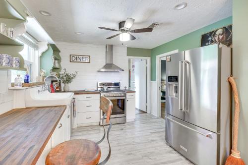 a large kitchen with a stainless steel refrigerator at Tomball Home with Game Room Walk to Main Street! in Tomball