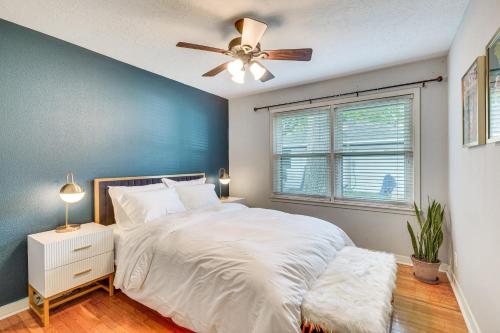 a bedroom with a white bed and a ceiling fan at Tomball Home with Game Room Walk to Main Street! in Tomball