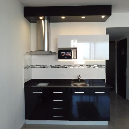 a kitchen with a sink and a microwave at Playa Blanca Town Center B in Playa Blanca