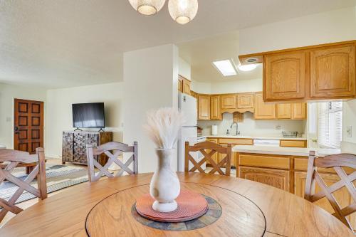 a kitchen with a table with a vase on it at 2 Mi to UNM Campus Home in Quiet Area of ABQ in Albuquerque