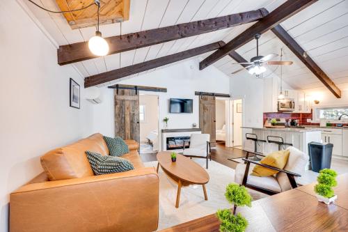 a living room with a couch and a table at Lofty Dreams Cabin By Conway Lake and Saco River! in Center Conway