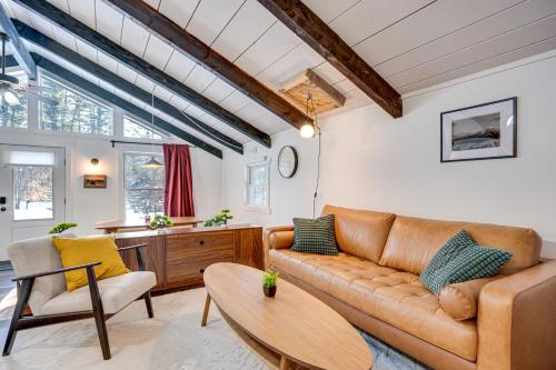 a living room with a couch and a table at Lofty Dreams Cabin By Conway Lake and Saco River! in Center Conway
