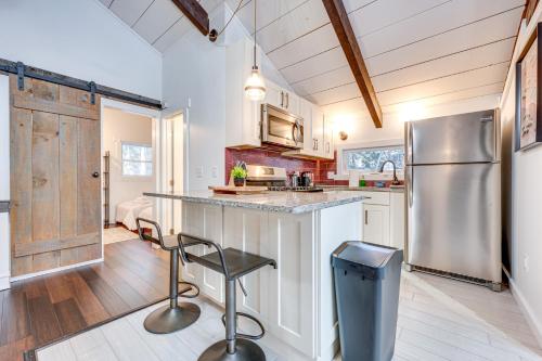 a kitchen with a stainless steel refrigerator and a counter at Lofty Dreams Cabin By Conway Lake and Saco River! in Center Conway