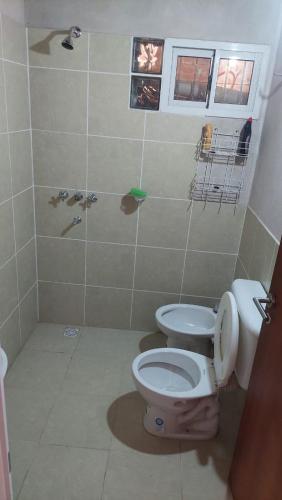 a bathroom with a toilet and a shower at Casa de Amaicha in Amaicha del Valle