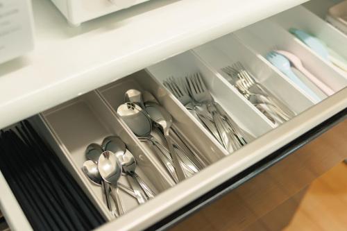 a drawer filled with silver utensils in a kitchen at Lapacho 子どもが絶対満足する宿 民泊らぱちょ in Kumamoto