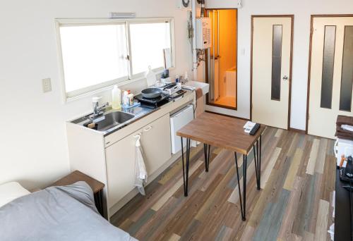 a small kitchen with a sink and a table at lol 3 201 in Hakodate