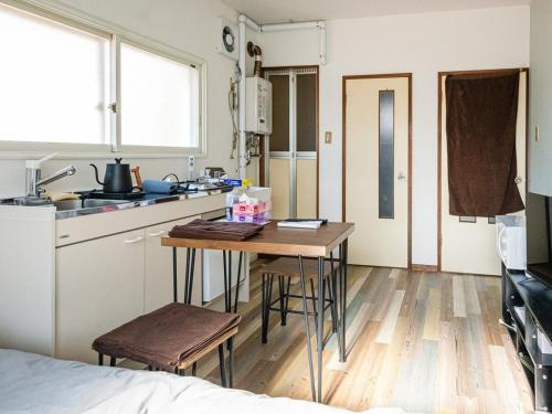 a small kitchen with a table and a sink at lol 3 201 in Hakodate