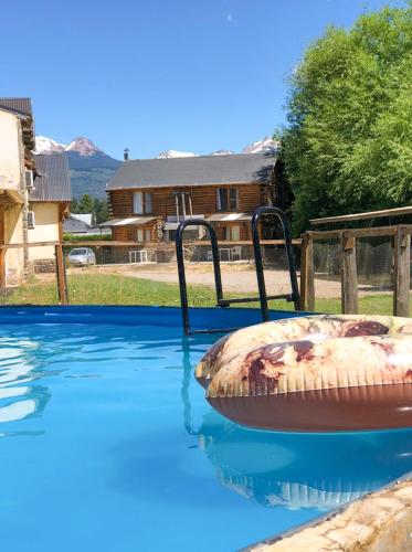 a swimming pool with a large object in the water at La Estancia in Trevelín