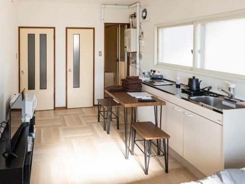 a kitchen with a table and chairs in a room at lol 3 202 in Hakodate