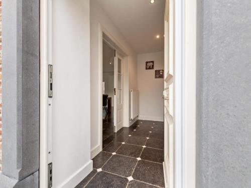 a hallway with a tile floor and white walls at Roborstje in Rooborst