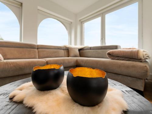 two black vases sitting on a table in a living room at Roborstje in Rooborst