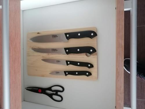 a bunch of knives hanging on a wall at Playa Blanca Town Center in Río Hato