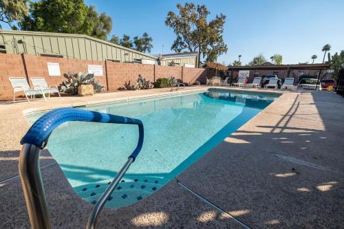 a swimming pool with a metal hand rail next to it at Msg for 5percent off 2Bed1and a half Bath KingQueenBeds CondoPHX in Phoenix