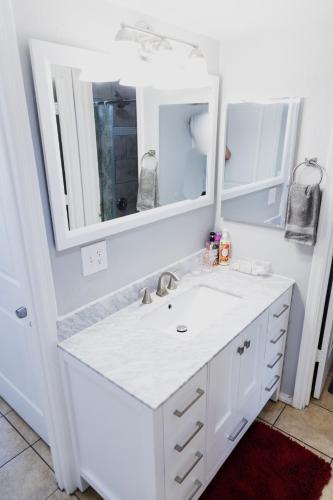 a bathroom with a white sink and a mirror at Msg for 5percent off 2Bed1and a half Bath KingQueenBeds CondoPHX in Phoenix