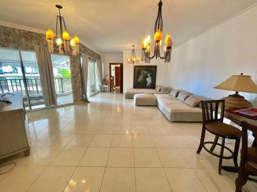 un ampio soggiorno con un divano e un tavolo di Spacious apartment beach access a Juan Dolio