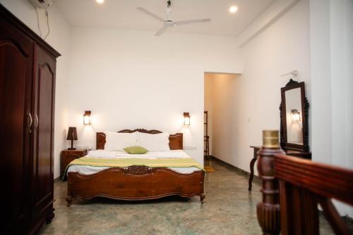 a bedroom with a bed and a ceiling fan at Sea Trails Bentota in Bentota