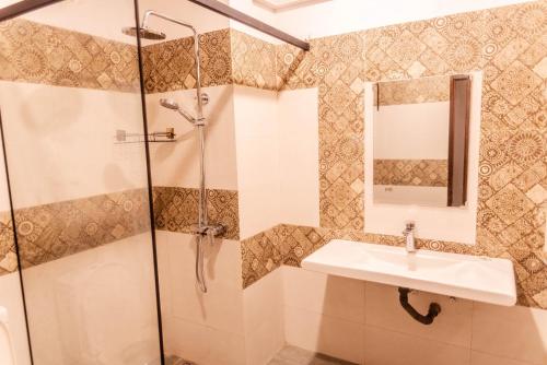a bathroom with a shower and a sink at Sea Trails Bentota in Bentota