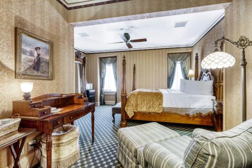 a hotel room with a bed and a desk at Beaumont Hotel and Spa - Adults Only in Ouray