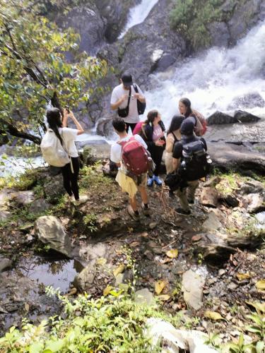 a group of people walking down a stream at Sierra de viboral adventures in Medellín