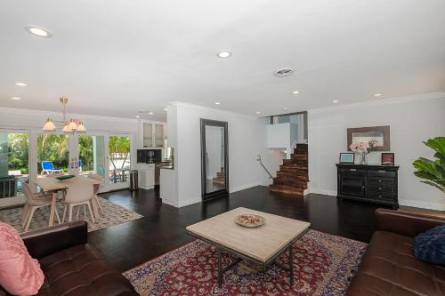 a living room with a couch and a table at Miami Dream Home/ Pool/Jacuzzi/ Fire Pit in Miami