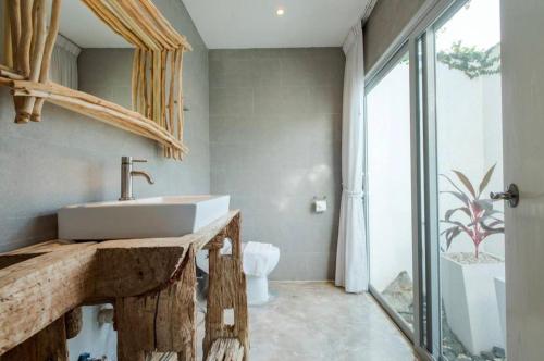 a bathroom with a sink and a mirror at The hideaway beach front villas in Ban Bo Nok