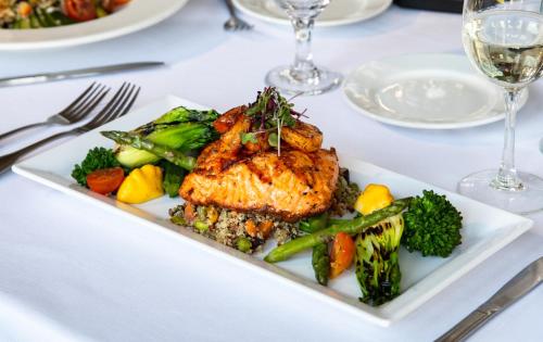 a plate of food with meat and vegetables on a table at Staybridge Suites Oxnard - River Ridge by IHG in Oxnard