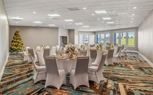 a conference room with a table and chairs and a christmas tree at Staybridge Suites Oxnard - River Ridge by IHG in Oxnard