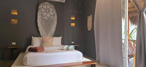 a bedroom with a white bed in a room at Hotel Kin Tulum Jungle Deluxe in Tulum