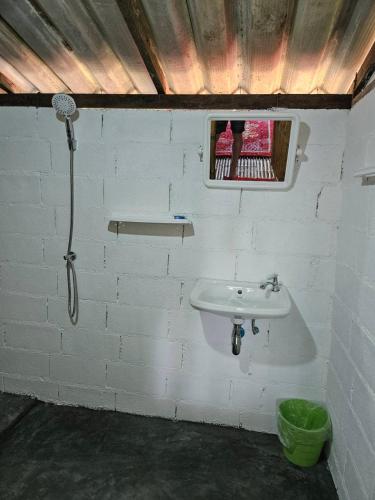 a bathroom with a sink in a brick wall at Rommai Forest Bungalows in Ko Lanta