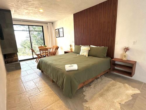 a bedroom with a bed and a table and a window at Casa Madera 1B in Zacatlán