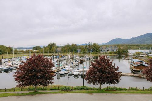 a bunch of boats are docked in a marina at The Moorage - Luxury 2 bed & 2 bath Condo on Marina in Ucluelet